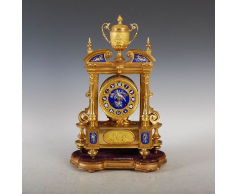 A 19th century ormolu, porcelain and enamel mounted mantle clock, the circular dial set with enamel on copper Roman numeral p