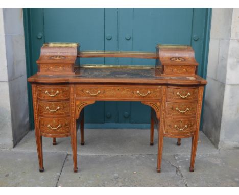 An Edwardian mahogany, marquetry and satinwood banded writing desk, probably Edwards &amp; Roberts, the upright back with an 