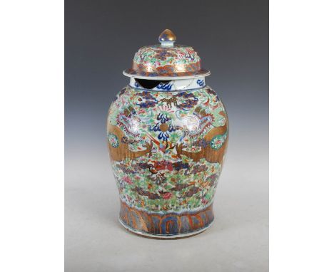 A Chinese porcelain blue and white temple jar and cover, Qing Dynasty, with clobbered famille rose decoration of two dragons 