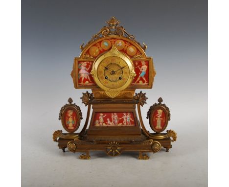 A late 19th century French Etruscan style gilt metal and porcelain mounted mantle clock, the circular dial with Roman numeral