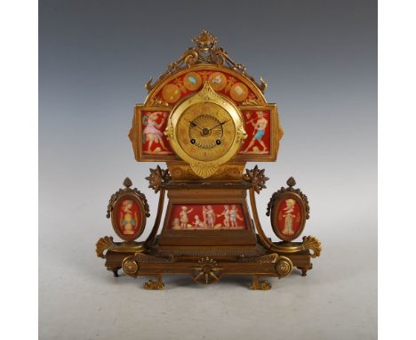 A late 19th century French Etruscan style gilt metal and porcelain mounted mantle clock, the circular dial with Roman numeral