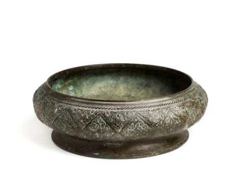 A CAST BRASS BOWL, SUMATRA, INDONESIA, 19TH CENTURY the convex sides with foliate lozenge design, on flared foot, 10cm high;3