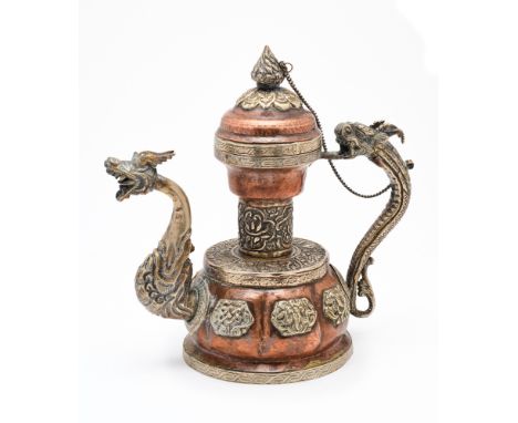 A COPPER AND BRASS TEAPOT, TIBET, 20TH CENTURY the lobed body with applique Buddhist emblems, with dragon handle and spout, t