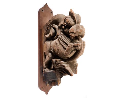 AN ARCHITECTURAL BRACKET IN THE FORM OF A MYTHICAL LION, SOUTH INDIA, 19TH CENTURY the rearing beast festooned with leaves, w