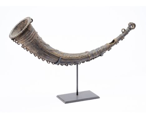 A BRASS BUGLE, CHATTISGARH, EASTERN INDIA, 19TH CENTURY of tapered crescent shaped form, with beaded and ropework decoration 