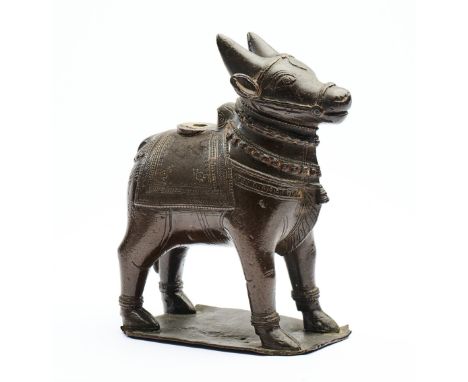 A BRONZE FIGURE OF NANDI BULL, TAMIL NADU, SOUTH INDIA, 18TH/19TH CENTURY standing on thin rectangular base, wearing blanket 
