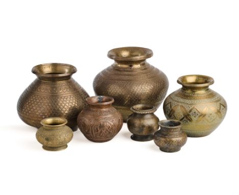 SEVEN METAL WATERPOTS (LOTA), INDIA, 19TH-20TH CENTURIES each of bulbous form with overhanging lip, four of brass with engrav