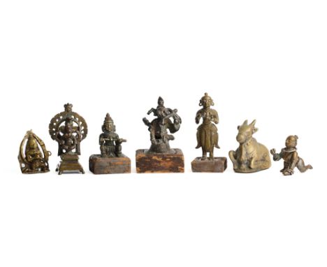 SEVEN HINDU BRONZE IMAGES, MOSTLY DECCAN, INDIA, 19TH CENTURY comprising two figures of Ganesha, one each of Nandi, Balakrish
