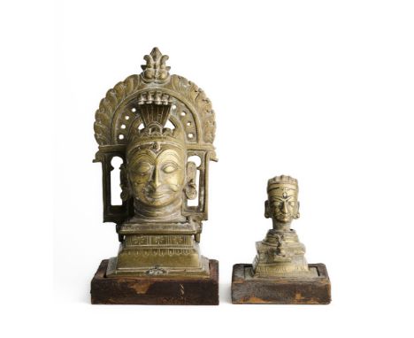 TWO BRONZE SIVALINGAM SHRINES, WESTERN DECCAN, 19TH CENTURY each in the form of a moustachioed head of Siva on a raised pedes