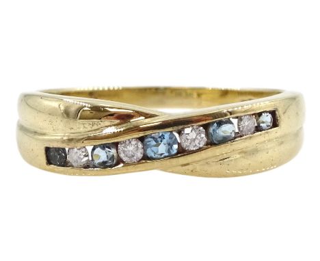 9ct gold channel set round blue topaz and diamond crossover ring, hallmarkedCondition Report:Approx 2.3gm, size N 3/4