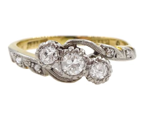 Gold three stone diamond crossover ring, with diamond set shoulders, stamped 18ct Plat, total diamond weight approx 0.30 cara