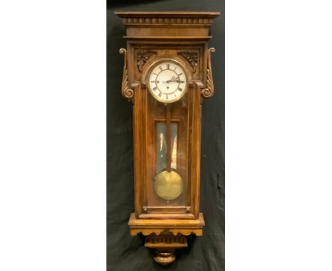 A Victorian oak carved Vienna wall clock, eight day movement, cream enamel dial, bold Roman numerals, dial is 18cm diameter, 