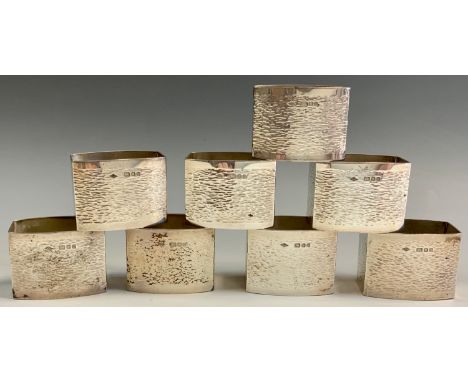 A set of eight textured silver rounded rectangular napkin rings, Graham Watling, London 1986, 257g (8) 