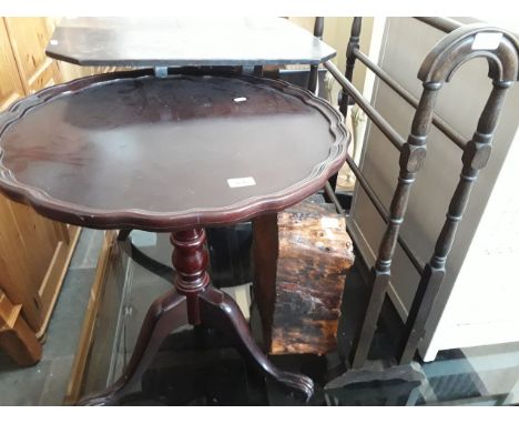 A reproduction tripod table, a towel rail and a wood stump. 
