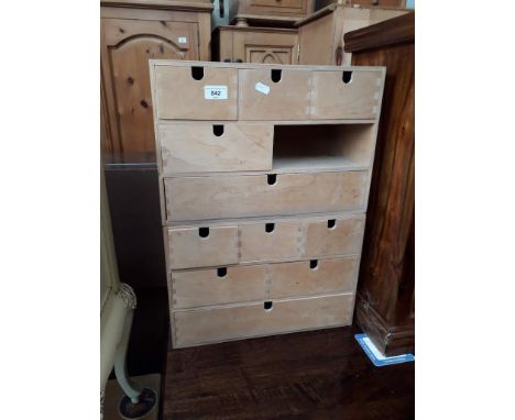A pair of light wood utility drawers. 