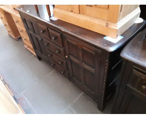 A Priory style Ercol sideboard.Condition: age related surface wear to edges, legs and top surface, no signs of any major stru