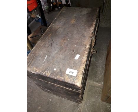 A wooden toolbox containing hand tools - chisels, hand drils etc