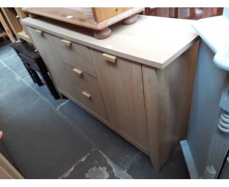 A modern light wood effect sideboard. 