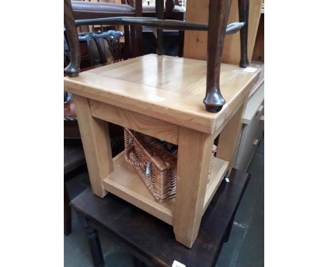 A light wood coffee table and a Fortnum &amp; Mason basket. 
