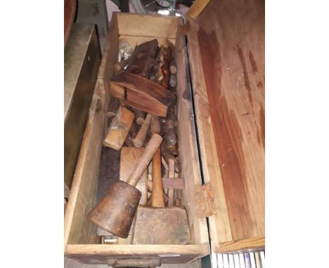 A wooden box containing a large quantity of woodworking tools 