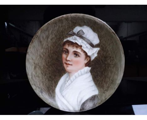 A hand painted portrait plate signed 'E Williams', diam. 24cm, old label verso. 