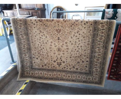 A beige ground carpet 163cm x 230cm. 