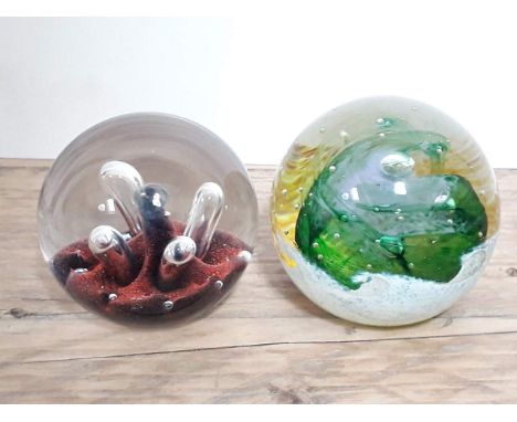 Two Caithness glass paperweights 'Moonflower' and 'Ocean Breeze'.Condition: some minor chips to surface of Moonflower with so