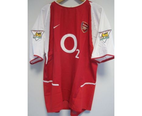 DENIS BERGKAMP MATCH WORN ARSENAL SHIRT               A red short sleeve shirt worn v. Newcastle United at Highbury 9/11/2002