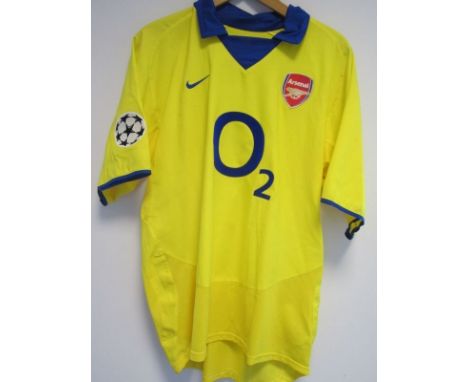 ASHLEY COLE PLAYER ISSUE ARSENAL SHIRT      A yellow short sleeve shirt with 3 Cole on the back and a Champions League arm fl