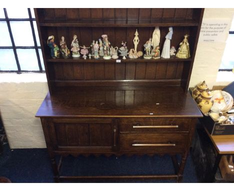 A 1920's/30's oak dresser, fitted one door, two drawers and shelf back.