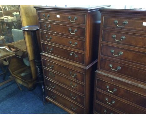 A reproduction mahogany chest on chest, fitted eight drawers on bracket feet by Bradleys.