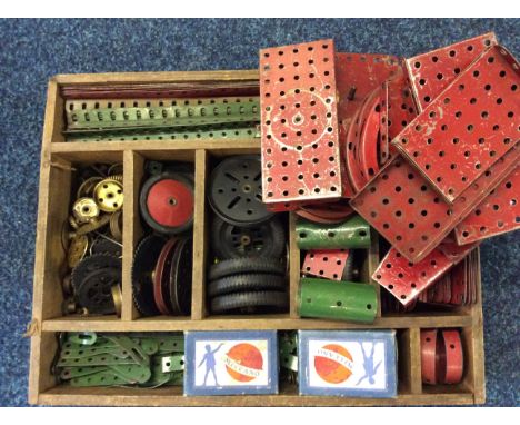 A Collection of vintage meccano pieces to include brass cogs and wheels etc in segmented wooden box.