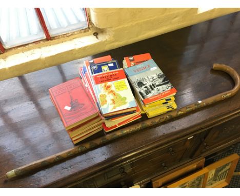 A selection of maps including Ward Lock’s together with a walking stick with souvenir plaques.