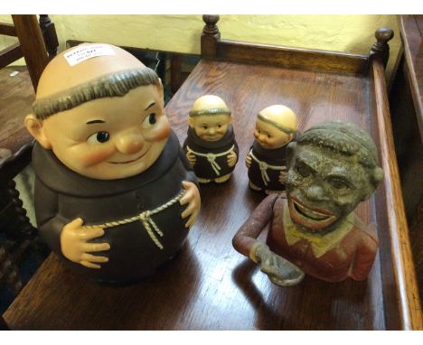 Three Goebel monk shaped storage pots, and a jolly boy money box.