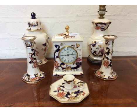 Six pieces of Masons 'Mandalay' china ware to include a mantle clock, table lamp, candlesticks, vase with lid.