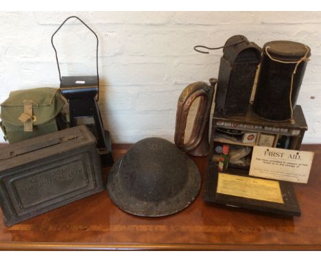 A Collection of various WW2 items to include English helmet, two gas masks, 30.M ammunition box, first aid box with contents,