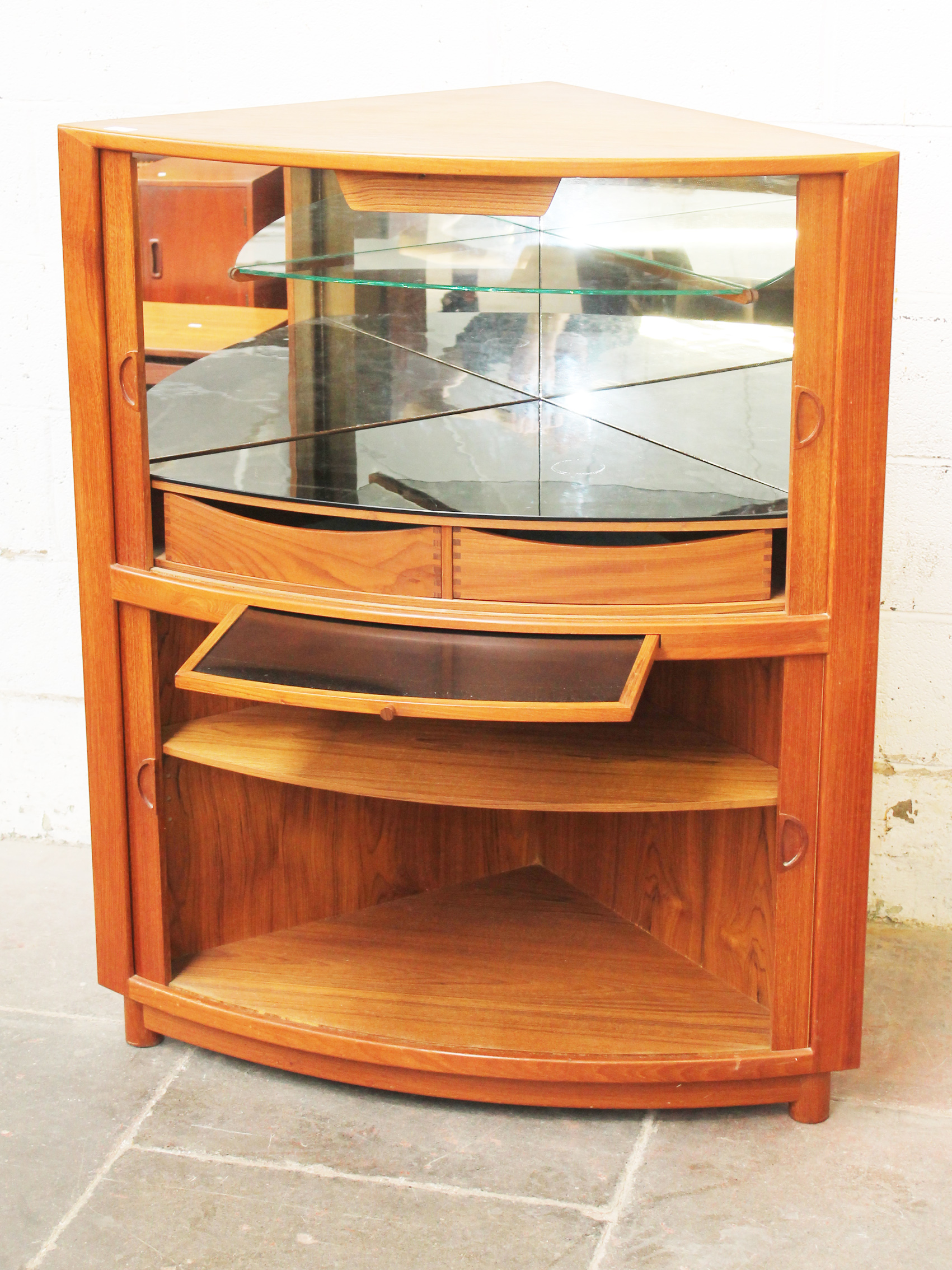 A Danish teak corner cocktail with tambour doors and glass