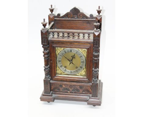 An oak mantel clock with brass and steel dial. H45cm