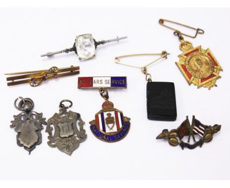 A mixed lot comprising a 9ct gold bar brooch, two silver fobs, a silver brooch, two enamel badges and two others