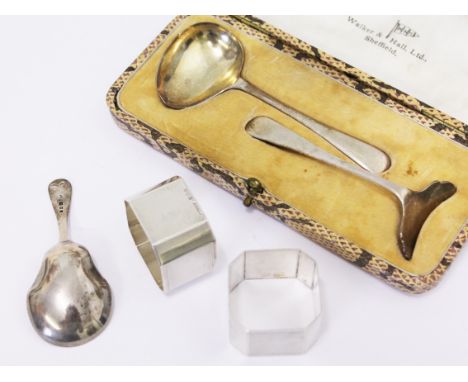 A mixed lot of hallmarked silver comprising a childs pusher set, a tea caddy and two napkin rings