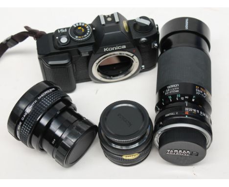 A Konica FS-1 camera and three lenses. Condition - lenses appear free from fungus but there're specs of dust, all mechanical 
