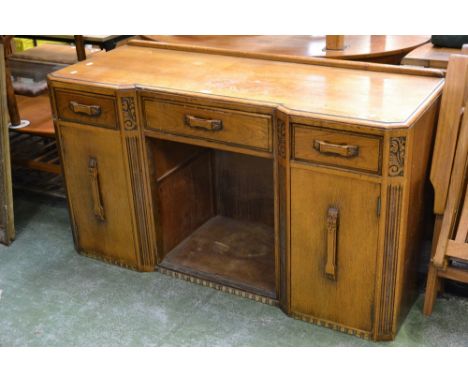 A 1940's light oak inverted breakfront sideboard, long drawer flanked short over recess and cupboards.