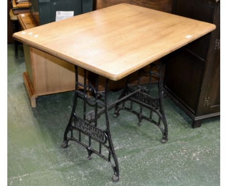 A Singer sewing treadle base table with light oak top 