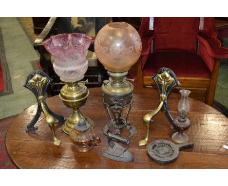 A pair of brass and cast iron art nouveau andirons; an improved lampe belge oil lamp; other lamps; an art nouveau vase/lamp s