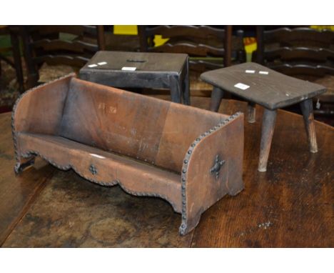 An unusual leather bound and studded book trough; two miniature stools (3)