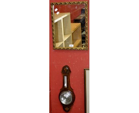 A Lancaster and Thorpe oak aneroid barometer; a gilt framed mirror (2) 