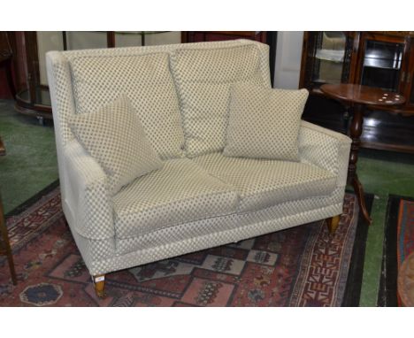 A mahogany Duresta two seater sofa with brass casters  