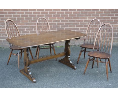 An Ercol style dining table with four Ercol spindle back dining chairs