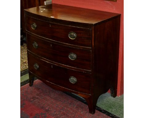 A George III mahogany bow front chest of three graduated cockbeaded drawers, bracket feet, c.1810