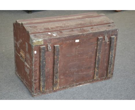 A dome top metal bound travel trunk.
